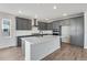 Contemporary kitchen with gray cabinets, stainless steel appliances, and a center island with white countertop at 24661 E 33Rd Dr, Aurora, CO 80019