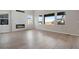 Spacious living room featuring modern fireplace with decorative tile surround and large windows at 24661 E 33Rd Dr, Aurora, CO 80019
