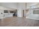 Open concept floor plan featuring a modern kitchen with white countertops and a staircase at 24661 E 33Rd Dr, Aurora, CO 80019