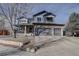 Two-story home with stone accents and a three-car garage at 10841 Willow Reed Cir, Parker, CO 80134