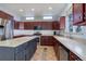 Large kitchen with granite countertops and dark wood cabinets at 10841 Willow Reed Cir, Parker, CO 80134