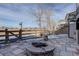 Stone patio with firepit and partial view of backyard at 10841 Willow Reed Cir, Parker, CO 80134