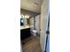 Well-lit bathroom with modern fixtures, vanity and tiled shower at 1469 S Reed St, Lakewood, CO 80232