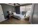 Comfortable bedroom featuring neutral tones, hardwood floors and a large window at 1469 S Reed St, Lakewood, CO 80232