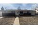 Single-story home with brick accents, a well-maintained lawn and a welcoming walkway at 1469 S Reed St, Lakewood, CO 80232
