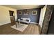 Open-concept living room with hardwood floors, modern decor, and neutral color palette at 1469 S Reed St, Lakewood, CO 80232