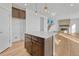 Modern kitchen with wood cabinets, quartz countertops, a center island, and direct access to the living room at 246 Mohawk Cir, Superior, CO 80027