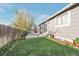 Lovely backyard with concrete patio, nice lawn, and wooden fence at 2707 S Richfield St, Aurora, CO 80013