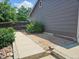Backyard with sidewalk alongside house and rock and wood chip garden areas at 2707 S Richfield St, Aurora, CO 80013