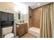 Well-maintained bathroom featuring a shower-tub combo and modern fixtures at 2707 S Richfield St, Aurora, CO 80013