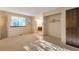 Spacious bedroom featuring carpet, a bright window and access to additional space at 2707 S Richfield St, Aurora, CO 80013
