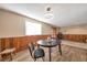 Dining area with wood paneled walls, modern lighting, and stylish decor at 2707 S Richfield St, Aurora, CO 80013