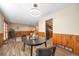 Well lit dining area with wood paneled walls and modern lighting at 2707 S Richfield St, Aurora, CO 80013