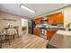 Well-lit kitchen with stainless steel appliances, wood cabinets, and tile flooring at 2707 S Richfield St, Aurora, CO 80013