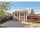Backyard shed offering extra storage space, with a neutral paint scheme and window at 2707 S Richfield St, Aurora, CO 80013