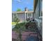 This view features a side yard with tidy landscaping and a brick walkway at 2707 S Richfield St, Aurora, CO 80013