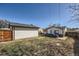 Backyard with well-maintained grass area, a detached garage, and a privacy fence at 433 S Xavier St, Denver, CO 80219