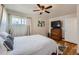Comfortable bedroom featuring a hardwood floors, ceiling fan, and a dresser with a TV at 433 S Xavier St, Denver, CO 80219