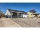 Charming single-story home featuring a covered porch, rockscape yard, and sunny exterior at 433 S Xavier St, Denver, CO 80219