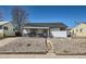 Charming single-story home with a rockscaped front yard and inviting covered porch at 433 S Xavier St, Denver, CO 80219