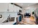 Bright kitchen features stainless steel appliances, white subway tile backsplash and sink at 433 S Xavier St, Denver, CO 80219