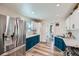 Updated kitchen with stainless steel refrigerator, white upper cabinets and blue lower cabinets at 433 S Xavier St, Denver, CO 80219