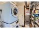 Functional laundry area with modern washer/dryer, storage shelves, and utility systems at 433 S Xavier St, Denver, CO 80219