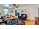 Cozy living room featuring hardwood floors, stylish rug, and comfortable seating arrangement at 433 S Xavier St, Denver, CO 80219