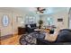 Bright living room featuring hardwood floors, stylish rug, and comfortable seating arrangement at 433 S Xavier St, Denver, CO 80219