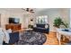 Comfortable living room featuring hardwood floors, stylish rug, and ample space for entertaining at 433 S Xavier St, Denver, CO 80219