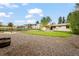 Expansive backyard featuring a pergola, gravel area, lawn, and multiple outbuildings at 6147 Dunraven St, Golden, CO 80403