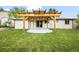 Green backyard featuring a pergola over a concrete patio with lawn and door access to the home at 6147 Dunraven St, Golden, CO 80403