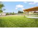 Manicured backyard with grassy play area and a covered pergola at 6147 Dunraven St, Golden, CO 80403