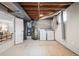 Unfinished basement area showing laundry hookups and mechanical equipment at 6147 Dunraven St, Golden, CO 80403