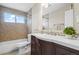 Well-appointed bathroom with a shower-tub combo, modern vanity, and stylish tile accents at 6147 Dunraven St, Golden, CO 80403