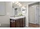 Stylish bathroom featuring a modern vanity, decorative mirrors, and elegant fixtures at 6147 Dunraven St, Golden, CO 80403