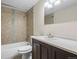 Bathroom featuring tiled shower over tub and vanity with dark wood cabinets at 6147 Dunraven St, Golden, CO 80403