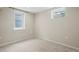 Neutral bedroom featuring two windows for natural light and neutral carpet at 6147 Dunraven St, Golden, CO 80403