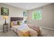 Cozy bedroom featuring a comfortable bed, side tables with lamps, and a bright window at 6147 Dunraven St, Golden, CO 80403