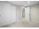 Neutral bedroom with sliding closet doors and a view into a bonus space at 6147 Dunraven St, Golden, CO 80403