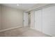 Neutral bedroom with closet and view into the bonus space at 6147 Dunraven St, Golden, CO 80403
