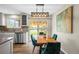 Cozy dining area with a wooden table, stylish chairs, and sliding glass doors to the backyard at 6147 Dunraven St, Golden, CO 80403