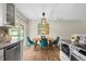 Charming dining room featuring a wooden table, plush chairs, and an elegant light fixture at 6147 Dunraven St, Golden, CO 80403