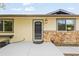 Welcoming front entrance with a stylish door, decorative lantern, and stone accents at 6147 Dunraven St, Golden, CO 80403