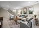 Basement living room with staircase access and comfortable seating arrangement at 6147 Dunraven St, Golden, CO 80403