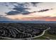 Scenic aerial view of a sprawling residential community with mountain views at sunset at 556 Rachael Pl, Castle Pines, CO 80108