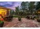 Stone back patio featuring outdoor seating, a dining table and chairs, and string lights at 556 Rachael Pl, Castle Pines, CO 80108