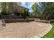 Backyard with gravel area bordered by stone walls, with a wooden fence, and lawn at 556 Rachael Pl, Castle Pines, CO 80108