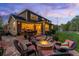 Inviting backyard with a stone patio featuring a fire pit and outdoor seating at 556 Rachael Pl, Castle Pines, CO 80108