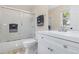 Bright bathroom with white cabinets, a tub, and sliding glass doors at 556 Rachael Pl, Castle Pines, CO 80108